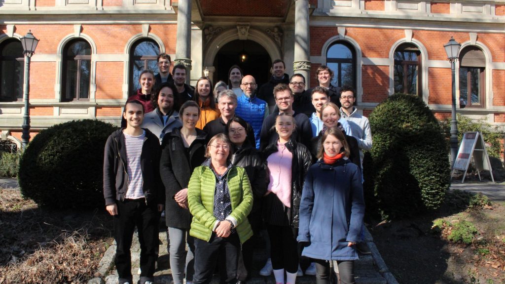 A group of scientists looks at the camera.